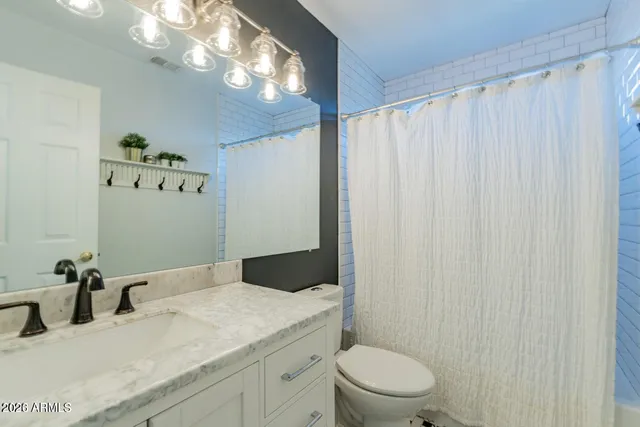 a room with exposed pipes and a window