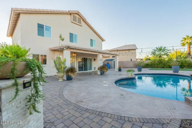 a swimming pool with outdoor seating and yard
