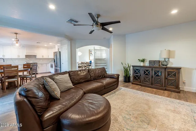 a bedroom with furniture and a large window