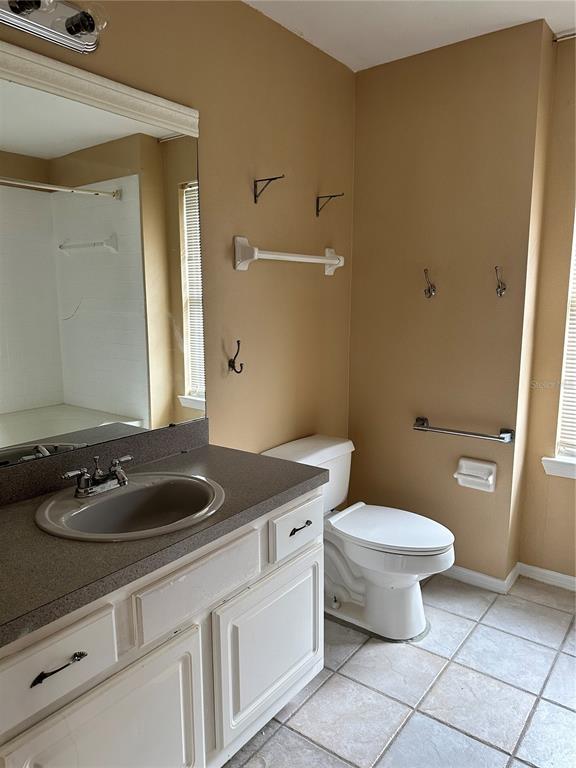 420 Summit Ridge Place, Unit 316 Longwood, FL 32779 - Photo 13 of 19 a bathroom with a granite countertop sink and a toilet