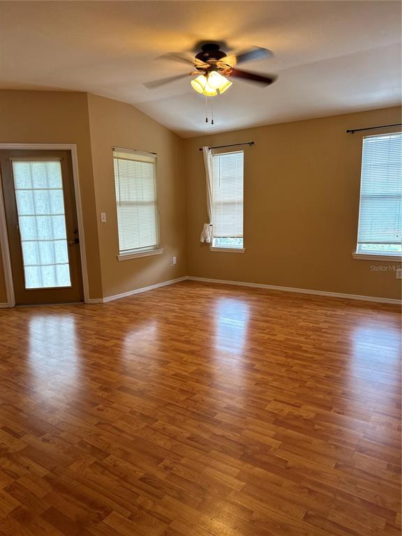 420 Summit Ridge Place, Unit 316 Longwood, FL 32779 - Photo 4 of 19 a view of an empty room with wooden floor and a window