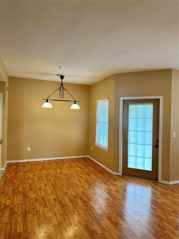 420 Summit Ridge Place, Unit 316 Longwood, FL 32779 - Photo 5 of 19 a view of wooden floor and windows in a room