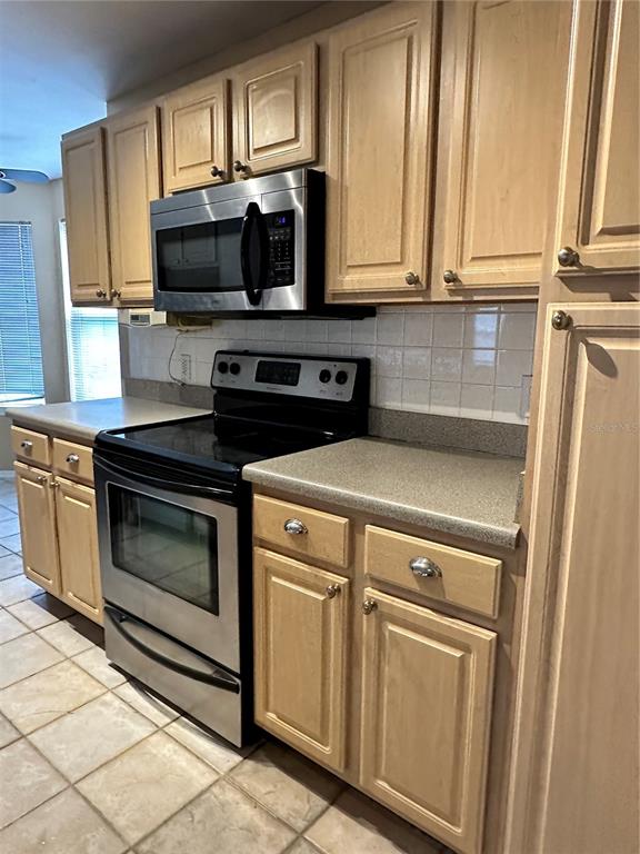 420 Summit Ridge Place, Unit 316 Longwood, FL 32779 - Photo 6 of 19 a kitchen with stainless steel appliances a stove microwave and sink