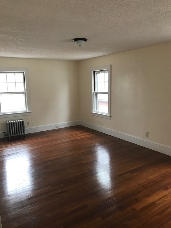 606 Alden Street Springfield, MA 01109 - Photo 15 of 22 an empty room with wooden floor and windows