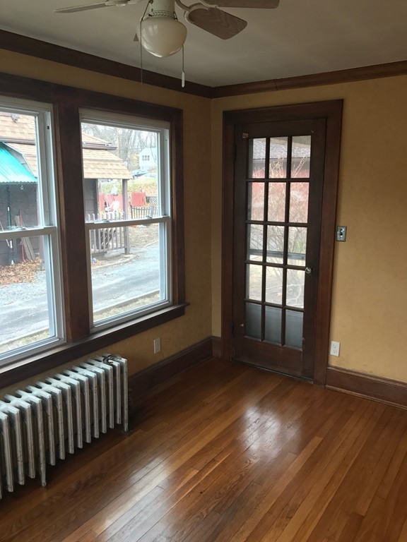 606 Alden Street Springfield, MA 01109 - Photo 7 of 22 an empty room with wooden floor and windows