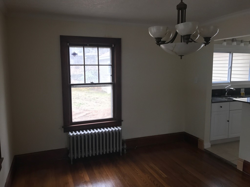 606 Alden Street Springfield, MA 01109 - Photo 8 of 22 a view of empty room with wooden floor and fan