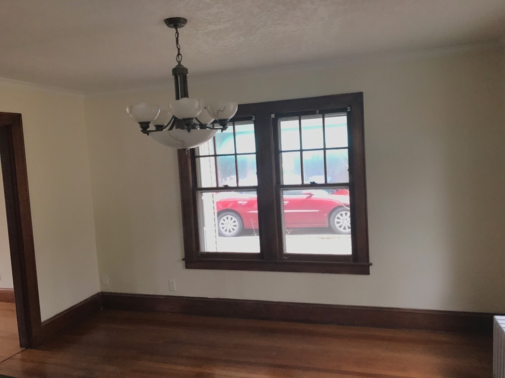 606 Alden Street Springfield, MA 01109 - Photo 9 of 22 a view of a hallway with wooden floor and windows