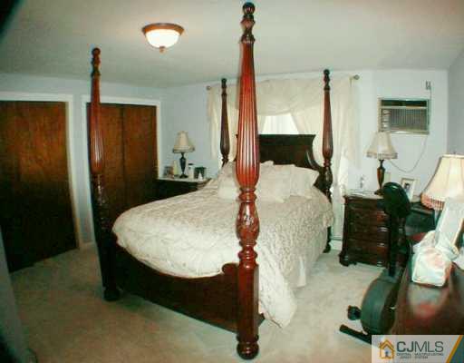 34 South Hill Road Colonia, NJ 07067 - Photo 7 of 8 a bed sitting in a bedroom next to a window