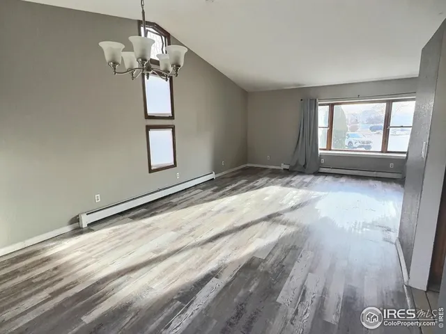 a kitchen with stainless steel appliances granite countertop a refrigerator a sink a stove top oven and a counter space