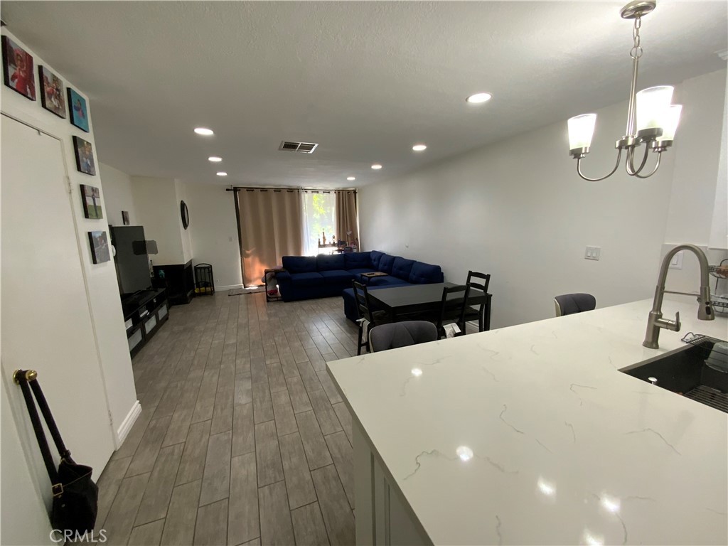 4140 Workman Mill Road, Unit 172 Whittier, CA 90601 - Photo 6 of 21 a living room with furniture and a wooden floor