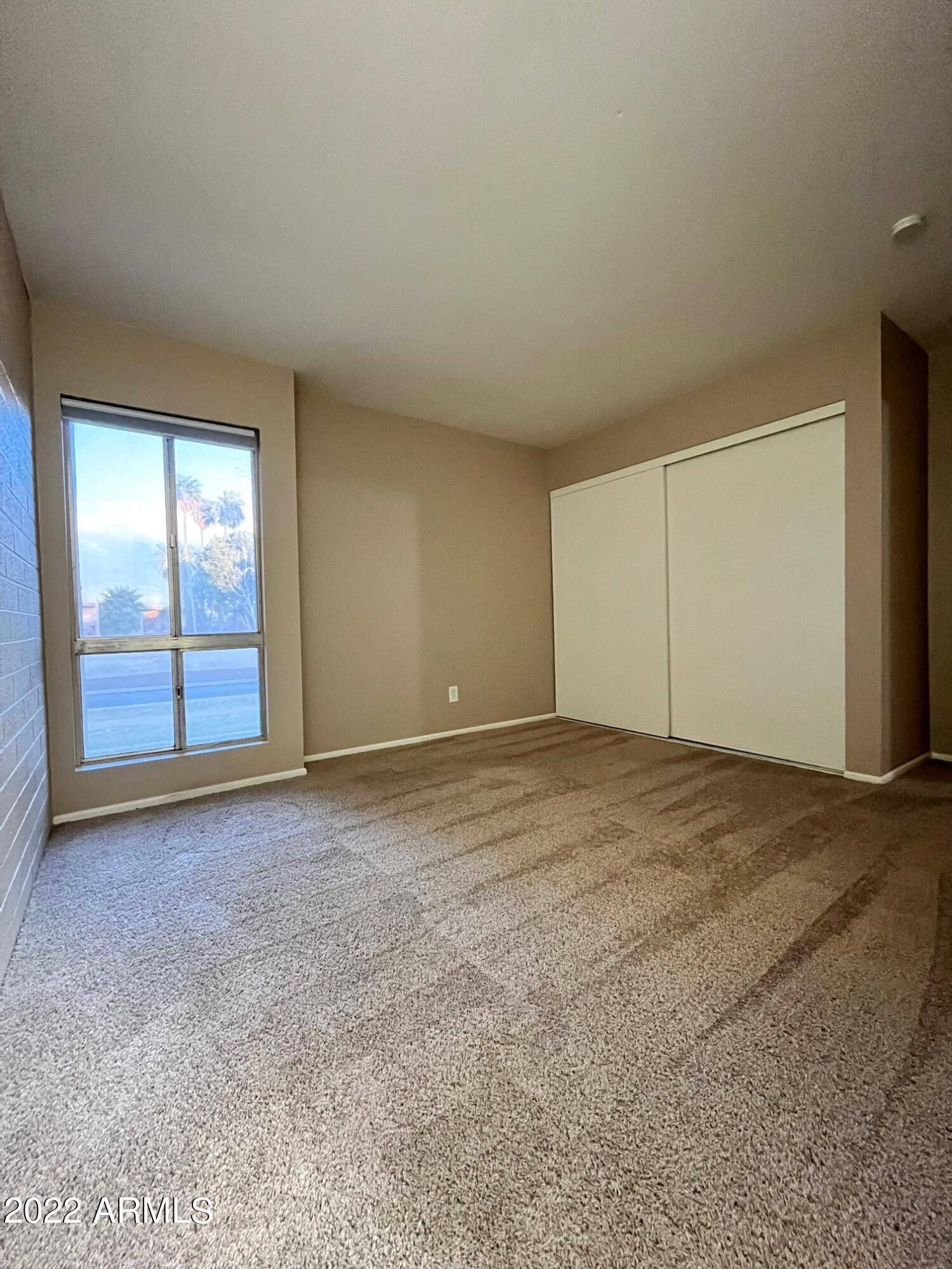 1701 West Tuckey Lane, Unit 225 Phoenix, AZ 85015 - Photo 9 of 13 a view of an empty room with a window