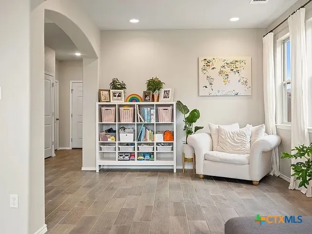 a living room with furniture and white walls