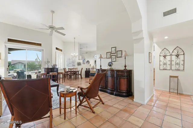 a dining room with furniture a chandelier and wooden floor
