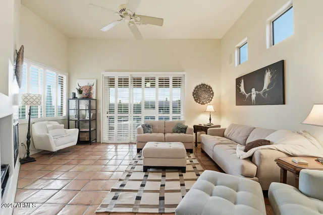 a bedroom with a bed a mirror on dresser and a fireplace