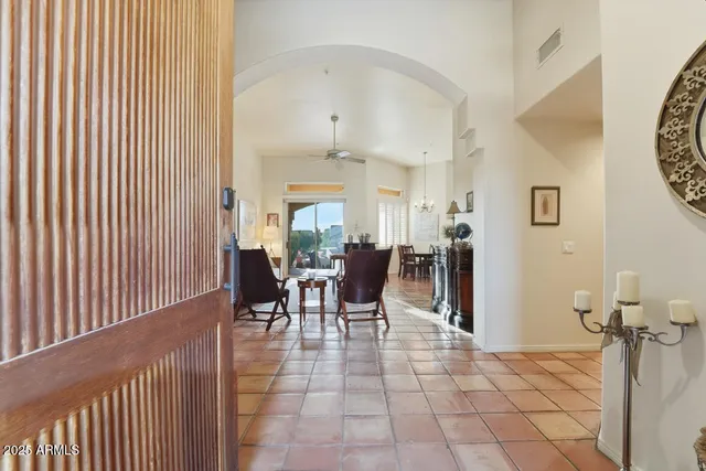 a view of a hallway to rooms and livingroom with furniture
