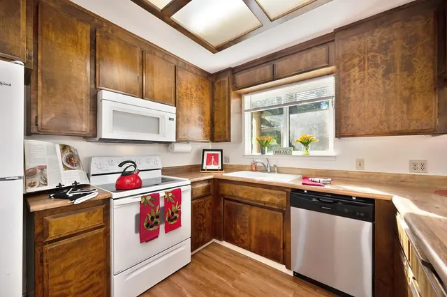 a kitchen with stainless steel appliances granite countertop a sink stove and cabinets