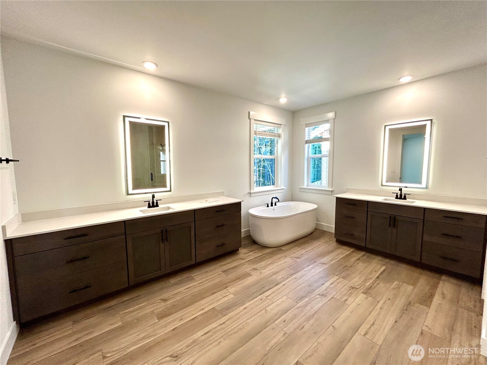 6034 Trce Drive Southwest Port Orchard, WA 98367 - Photo 25 of 40 a large bathroom with double vanity sink a two mirror a window a bathtub and vanity