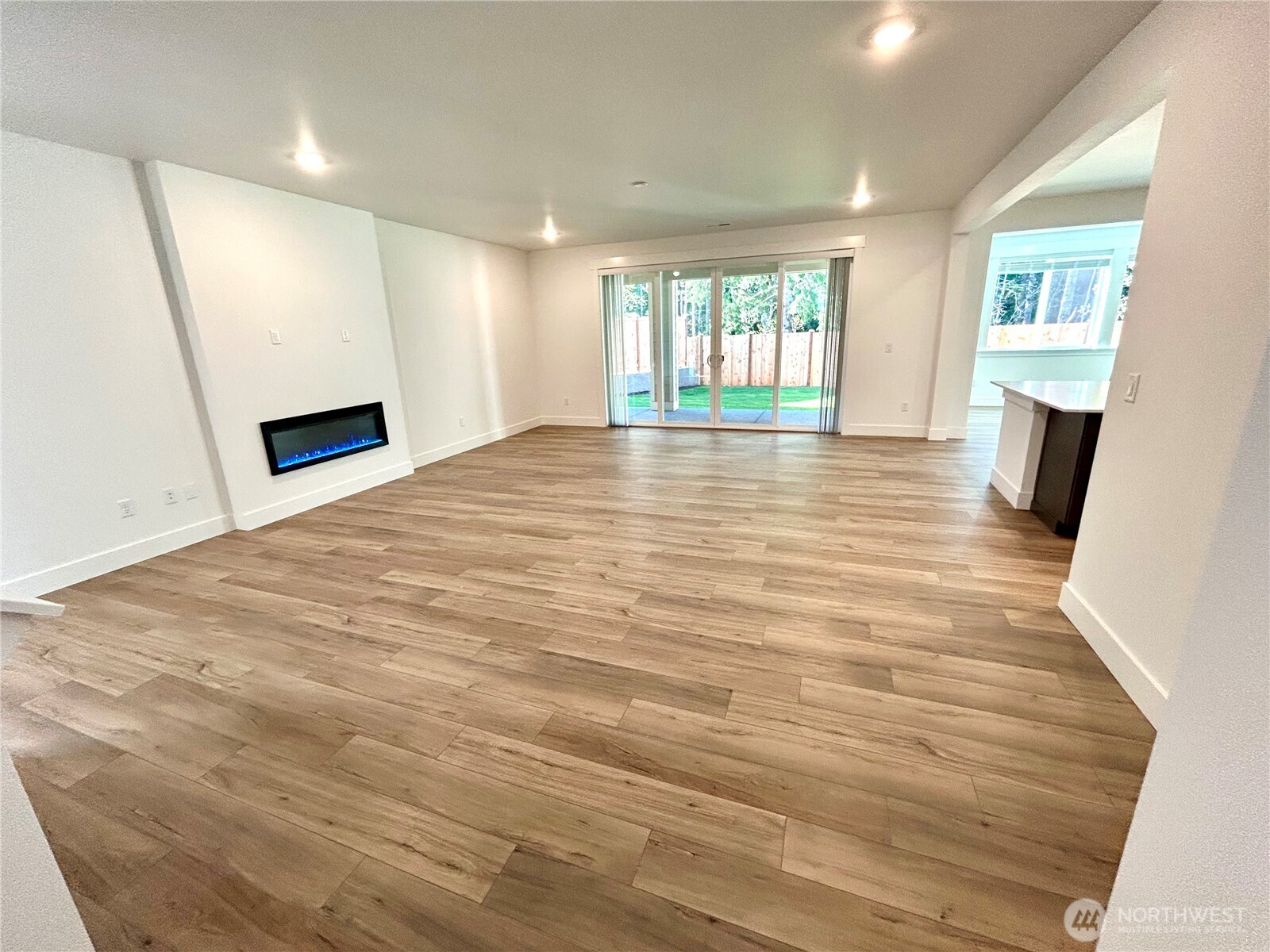 6034 Trce Drive Southwest Port Orchard, WA 98367 - Photo 4 of 40 a view of an empty room with a window and wooden floor