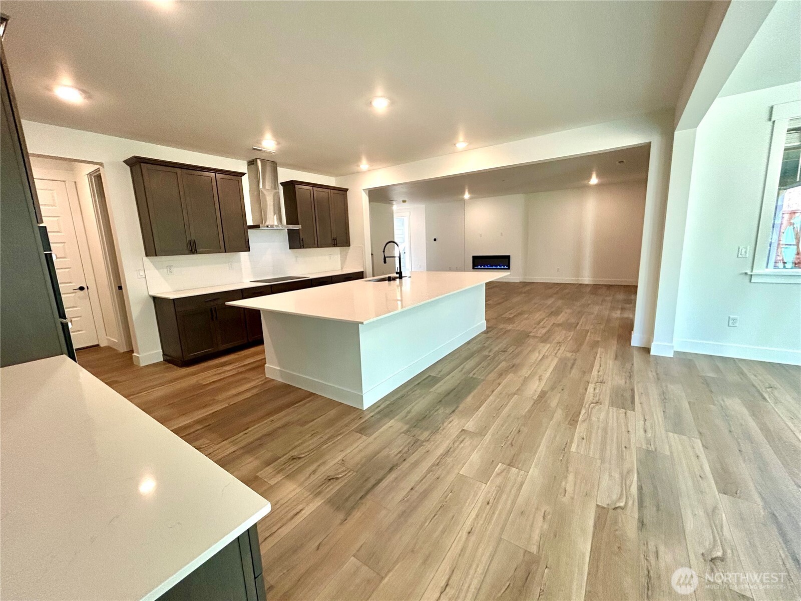 6034 Trce Drive Southwest Port Orchard, WA 98367 - Photo 7 of 40 a large room with wooden floor and furniture