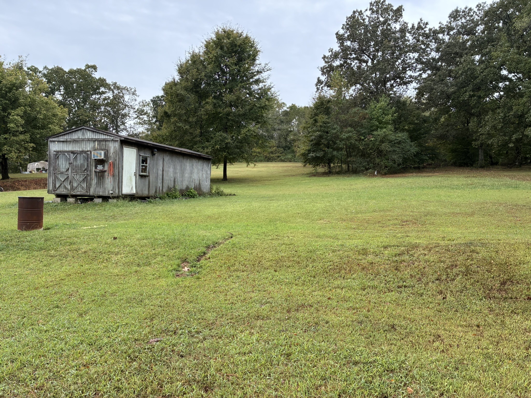 2765 Birdsong Road Camden, TN 38320 - Photo 3 of 18 a backyard of a house with lots of green space