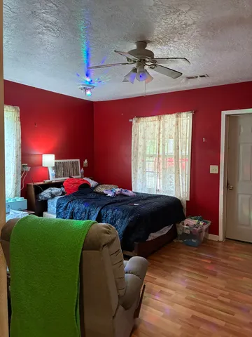 a bedroom with furniture and a chandelier