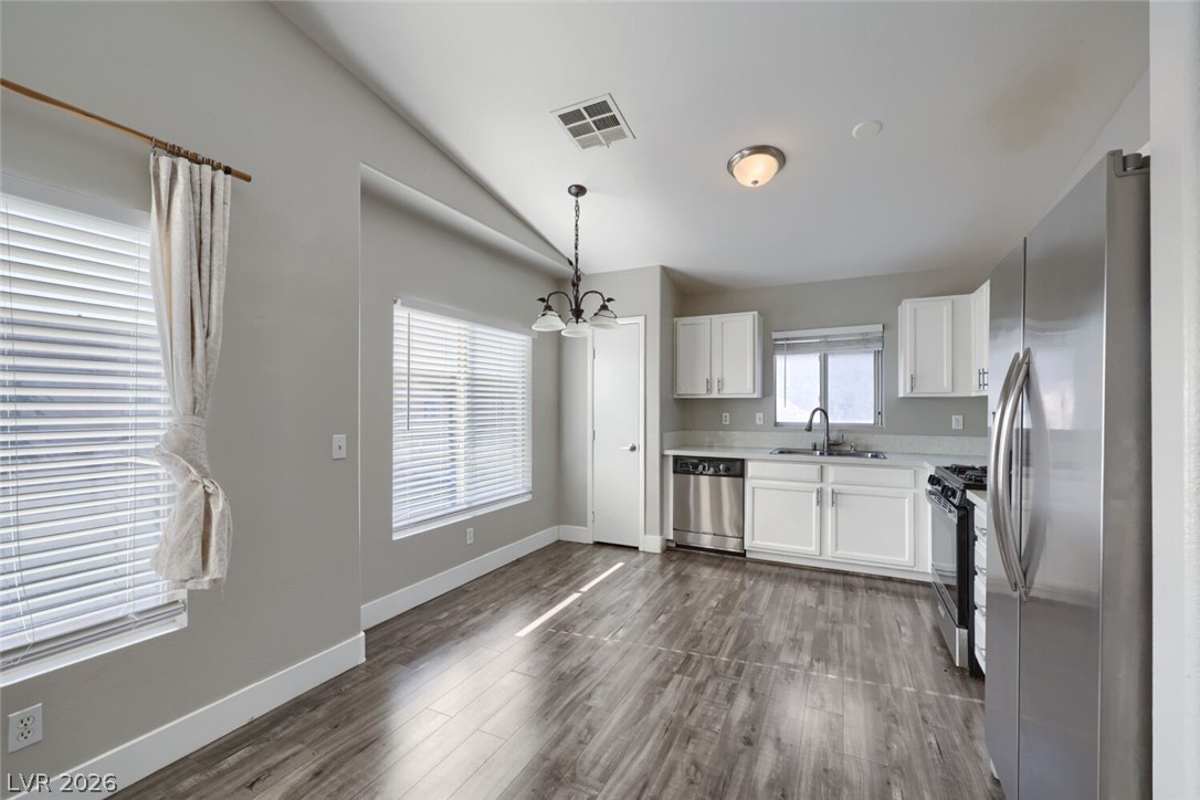 5985 High Steed Street, Unit 101 Henderson, NV 89011 - Photo 14 of 38 Functional kitchen with ample cabinet space, modern appliances, and a dining area.