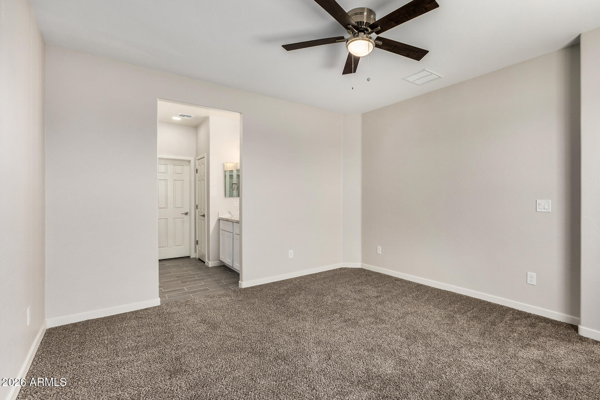 16022 South Naviska Road Arizona City, AZ 85123 - Photo 11 of 25 an empty room with closet and windows