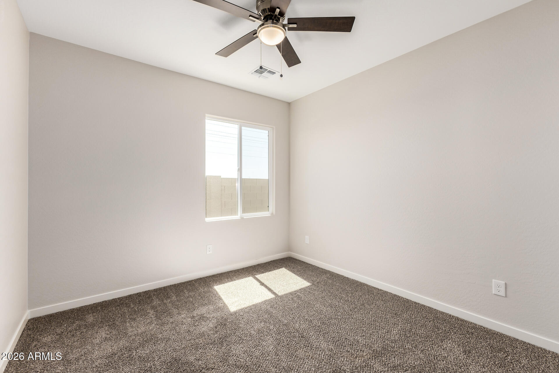 16022 South Naviska Road Arizona City, AZ 85123 - Photo 17 of 25 an empty room with a window and a fan