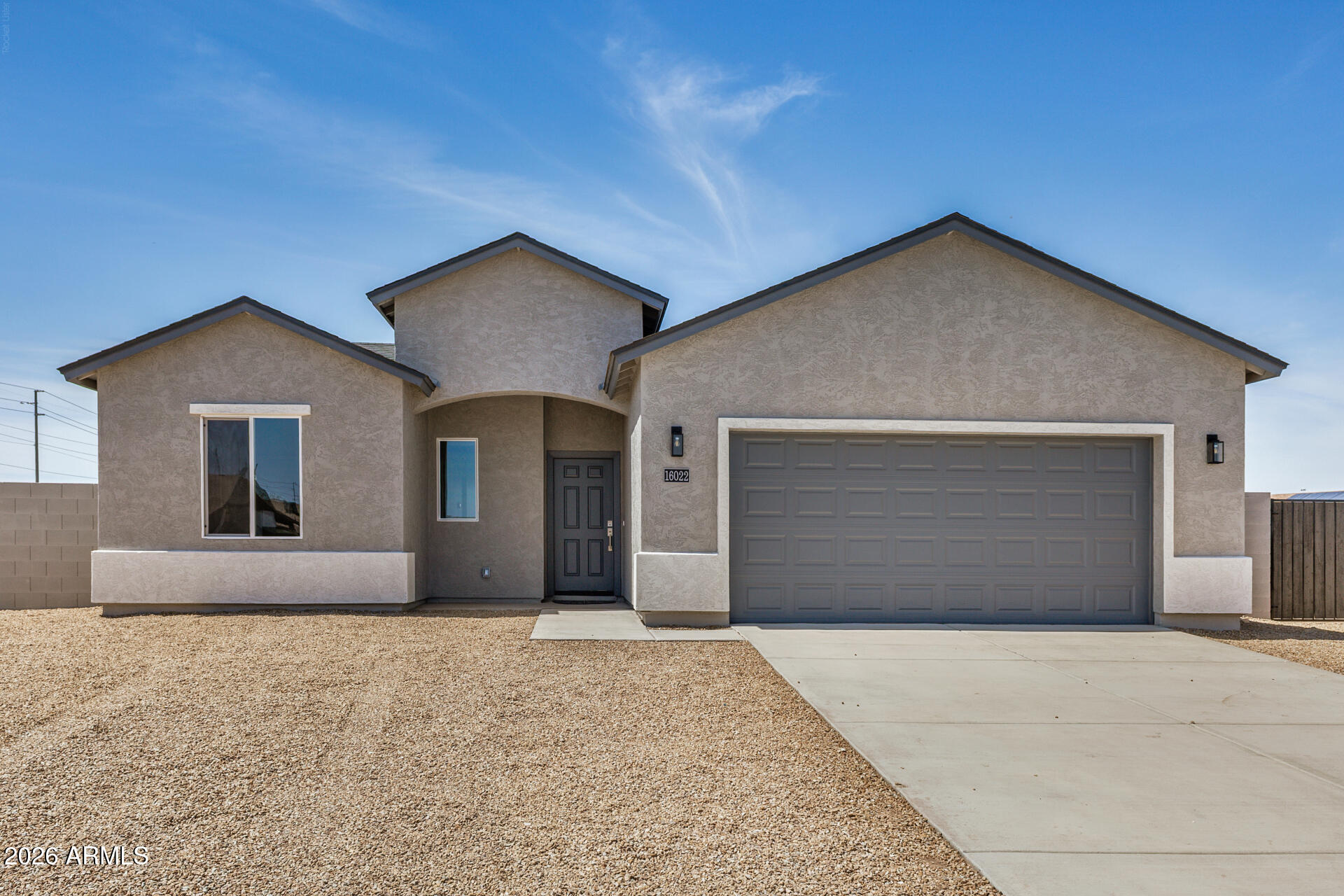 16022 South Naviska Road Arizona City, AZ 85123 - Photo 3 of 25 a front view of a house with a yard and garage