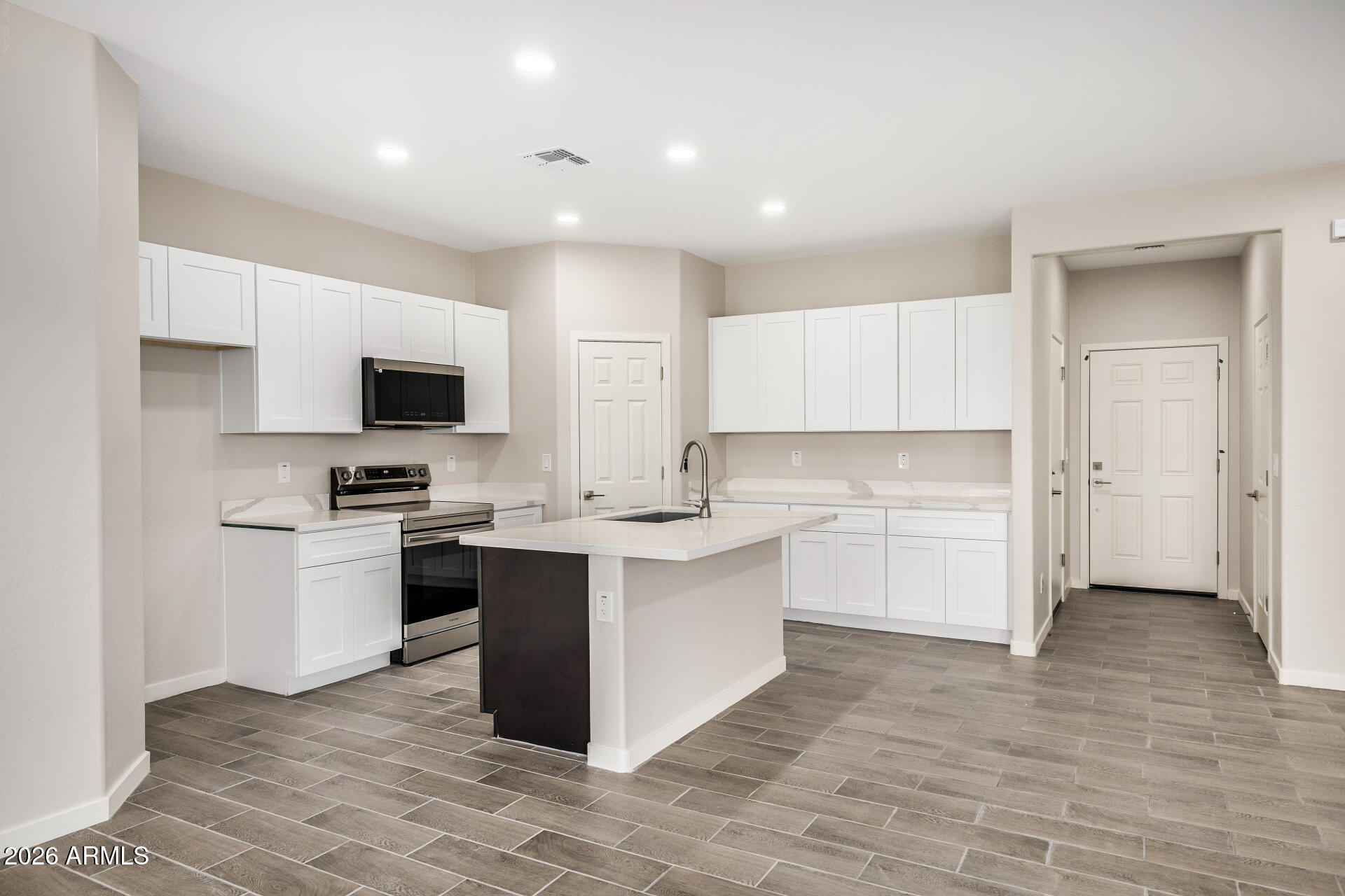 16022 South Naviska Road Arizona City, AZ 85123 - Photo 7 of 25 a kitchen with a sink cabinets and stainless steel appliances