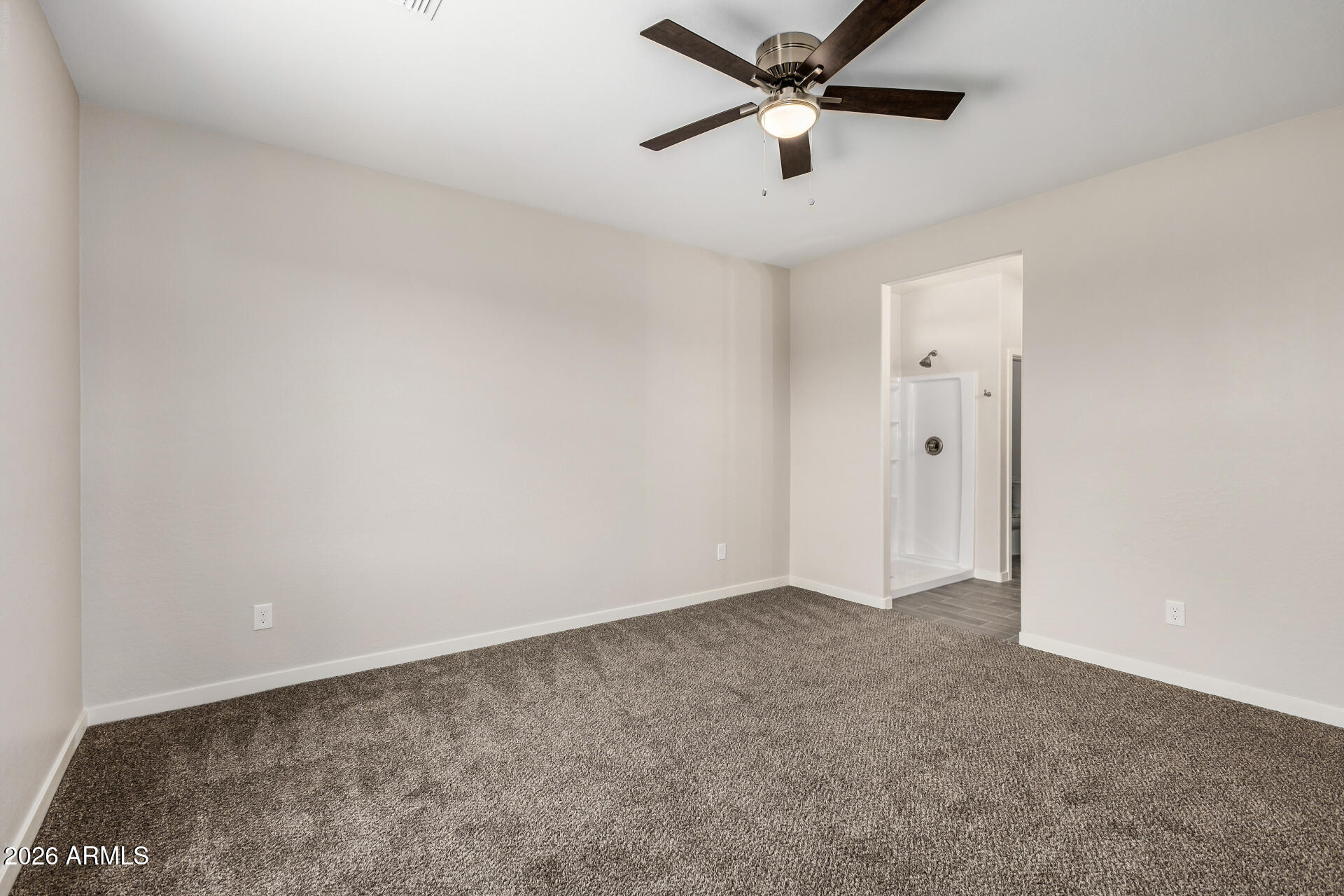 16022 South Naviska Road Arizona City, AZ 85123 - Photo 10 of 25 an empty room with a ceiling fan and a ceiling fan