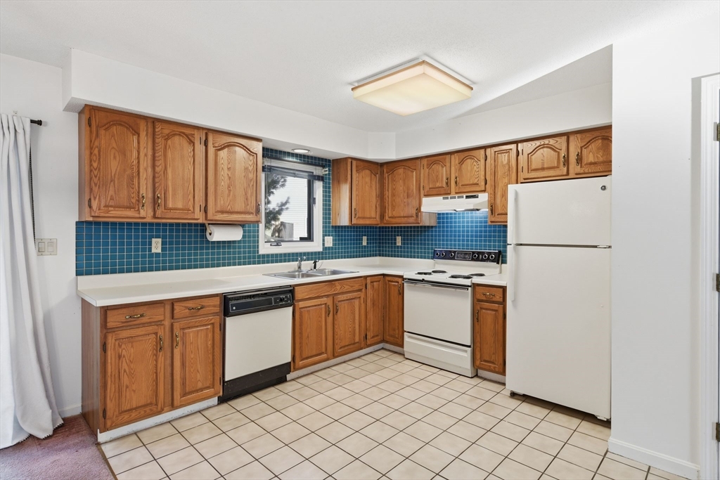 200 Lambert Terrace, Unit 70 Chicopee, MA 01020 - Photo 13 of 39 a kitchen with a refrigerator sink and cabinets