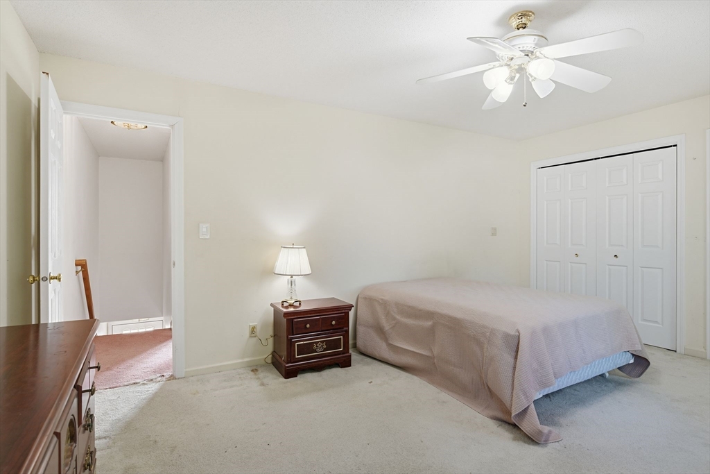 200 Lambert Terrace, Unit 70 Chicopee, MA 01020 - Photo 20 of 39 a spacious bedroom with a bed and a ceiling fan
