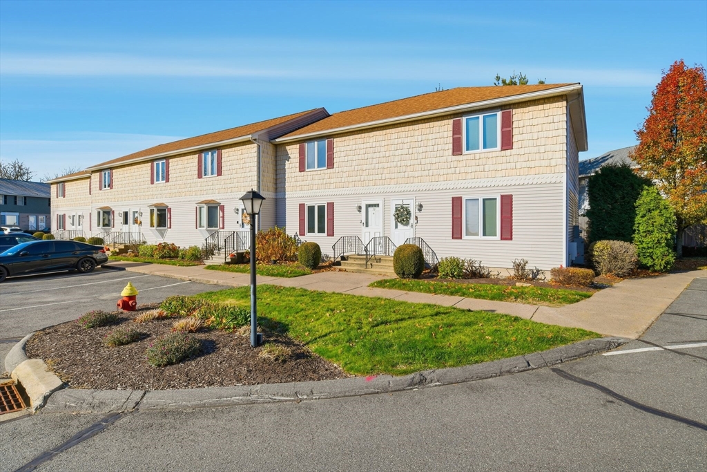 200 Lambert Terrace, Unit 70 Chicopee, MA 01020 - Photo 3 of 39 a front view of a house with a garden and patio
