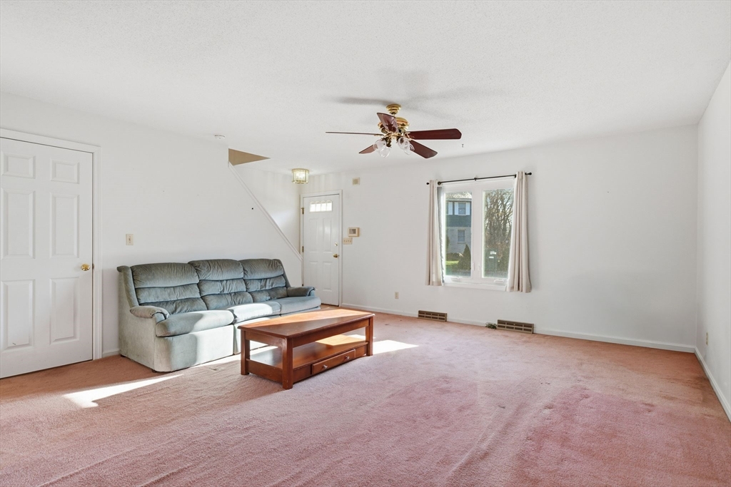 200 Lambert Terrace, Unit 70 Chicopee, MA 01020 - Photo 7 of 39 a living room with furniture and a ceiling fan