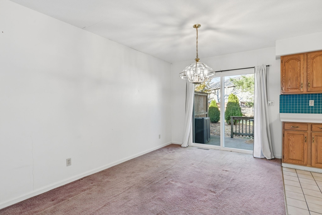 200 Lambert Terrace, Unit 70 Chicopee, MA 01020 - Photo 9 of 39 a view of a room with window and chandelier
