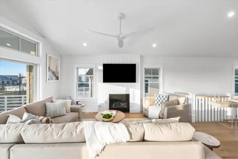 a living room with furniture a flat screen tv and a fireplace