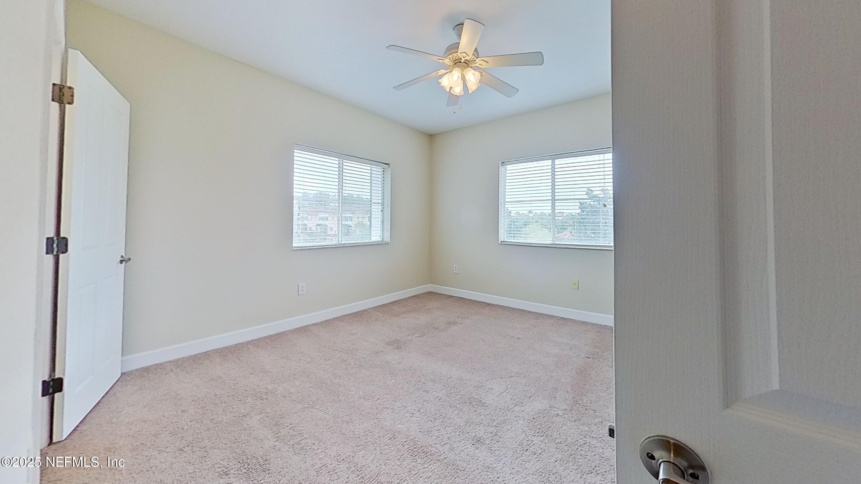 9745 Touchton Road, Unit 1421 Jacksonville, FL 32246 - Photo 11 of 22 an empty room with windows and fan
