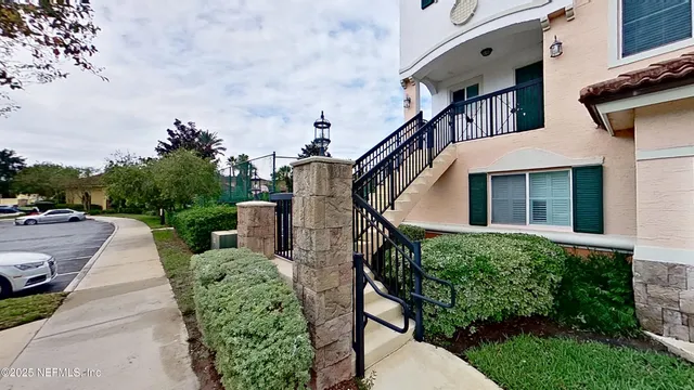 a view of a house with brick walls and plants