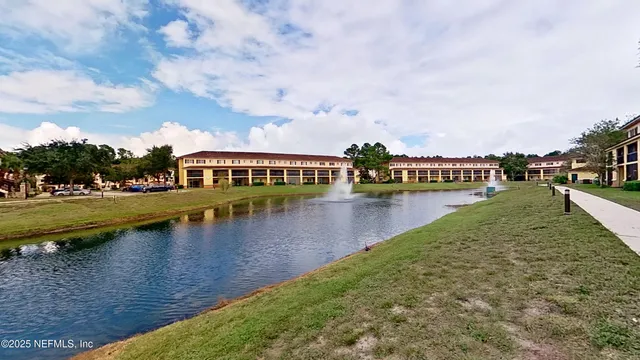 a view of residential house with outdoor space and lake