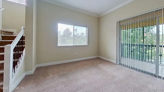 a view of an empty room with windows