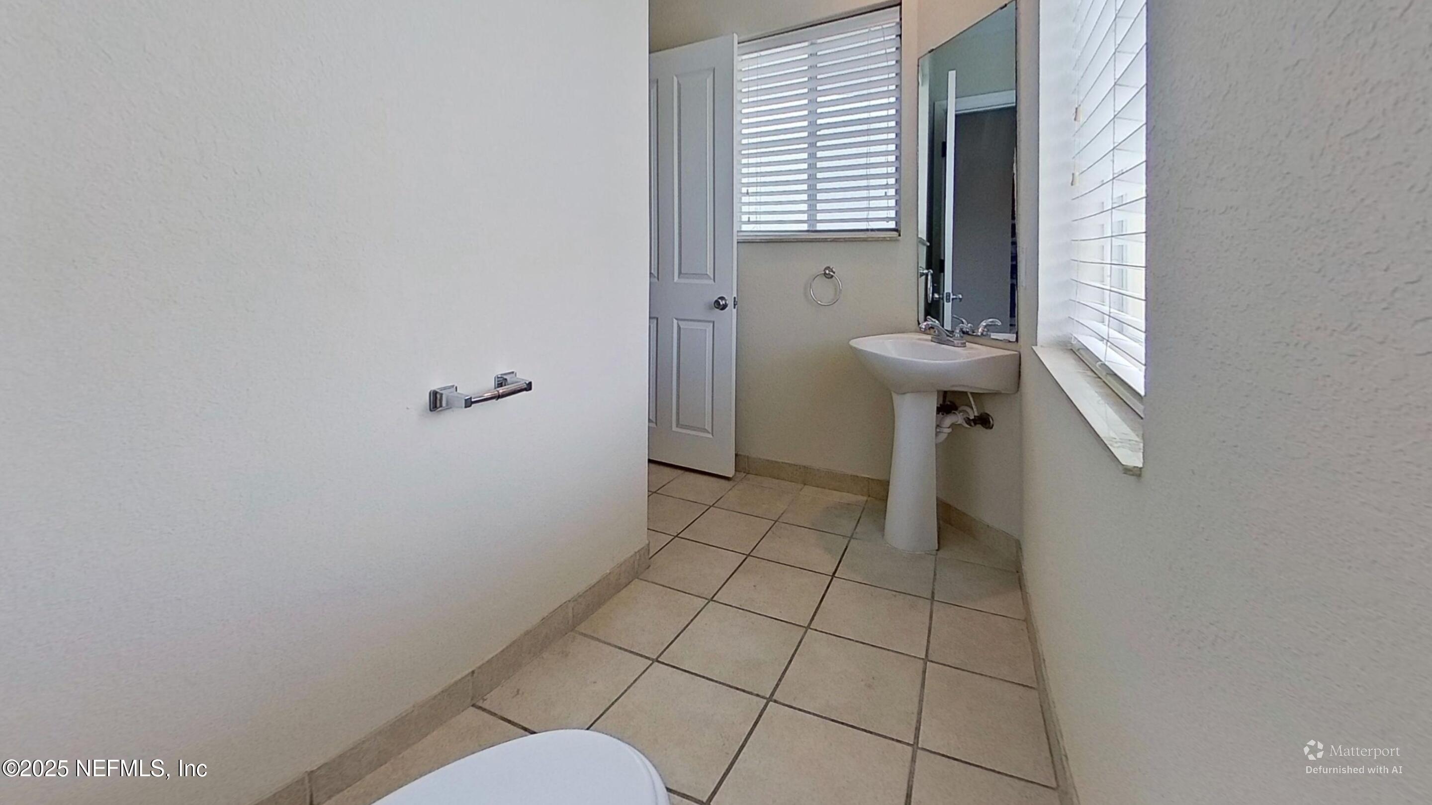 9745 Touchton Road, Unit 1421 Jacksonville, FL 32246 - Photo 9 of 22 a bathroom with a sink and a toilet