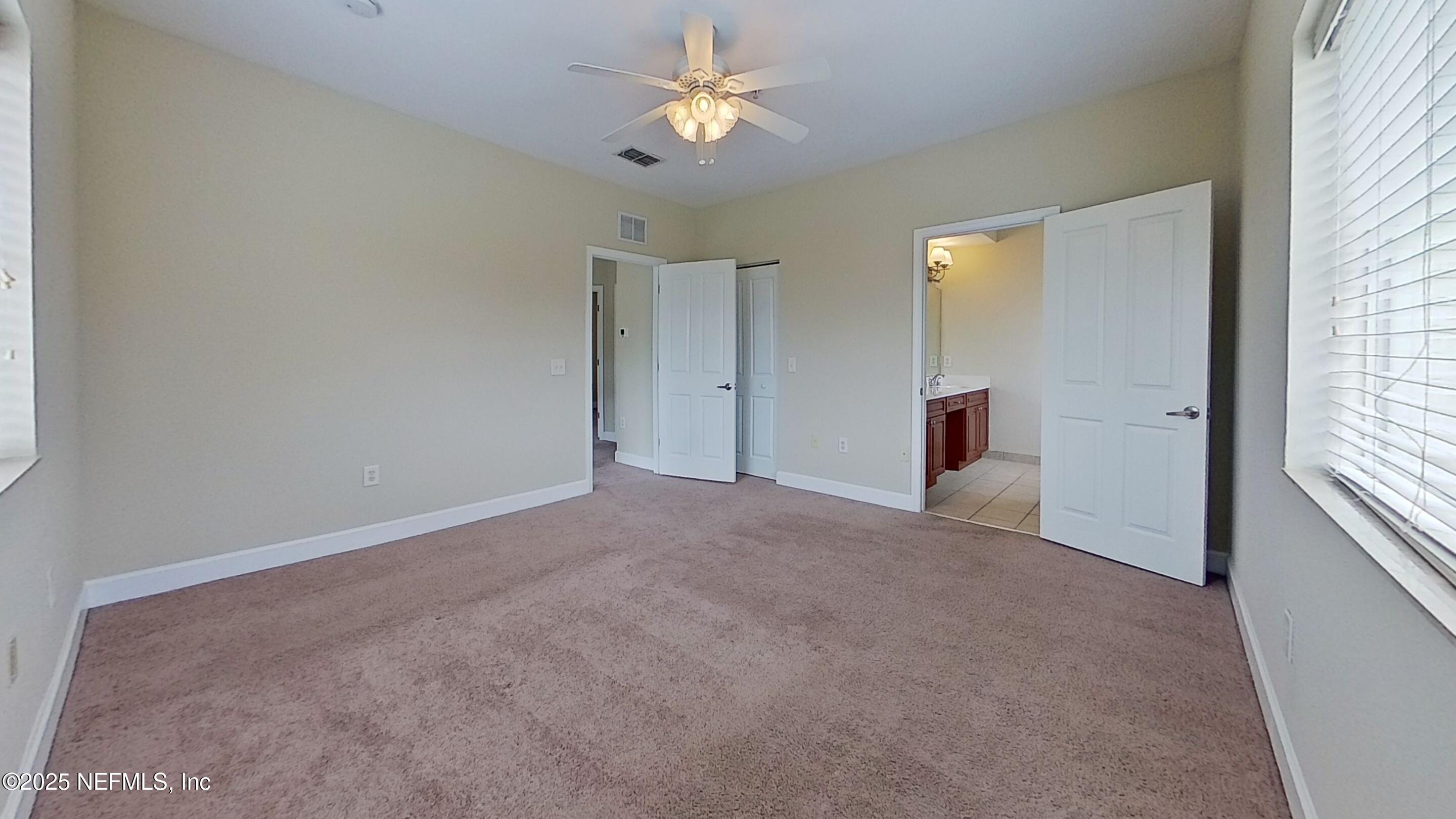 9745 Touchton Road, Unit 1421 Jacksonville, FL 32246 - Photo 10 of 22 a view of a big room with windows and chandelier fan