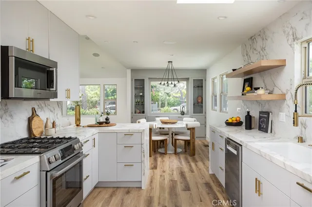 a kitchen with a stove a sink and a microwave