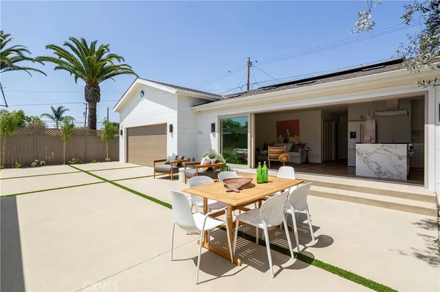 a view of a dining table and chairs in patio