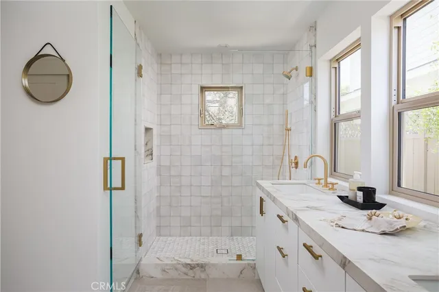 a bathroom with a granite countertop sink a shower and a mirror