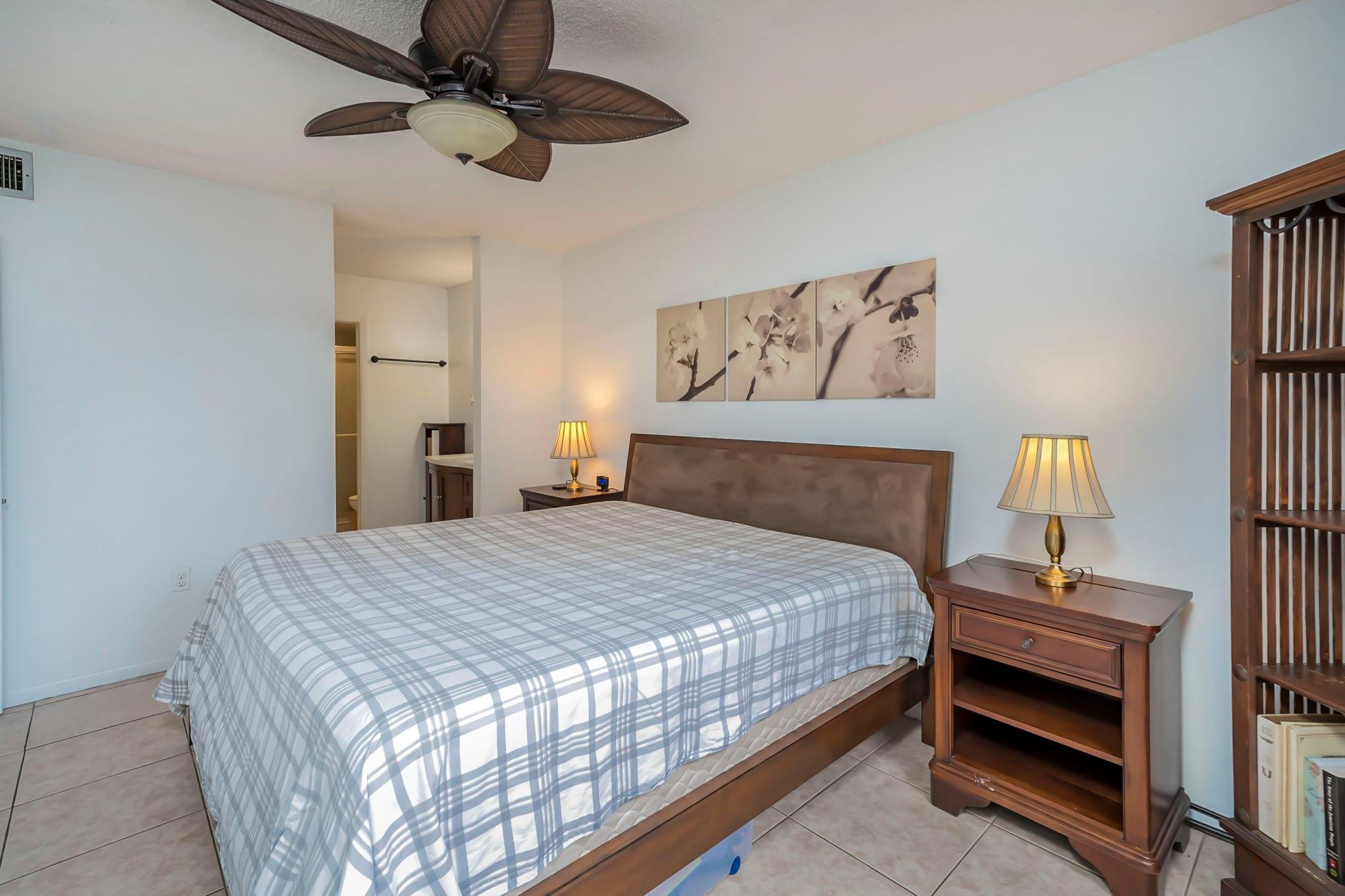 9401 Lime Bay Boulevard, Unit 209 Tamarac, FL 33321 - Photo 11 of 24 a bedroom with a bed and a chandelier