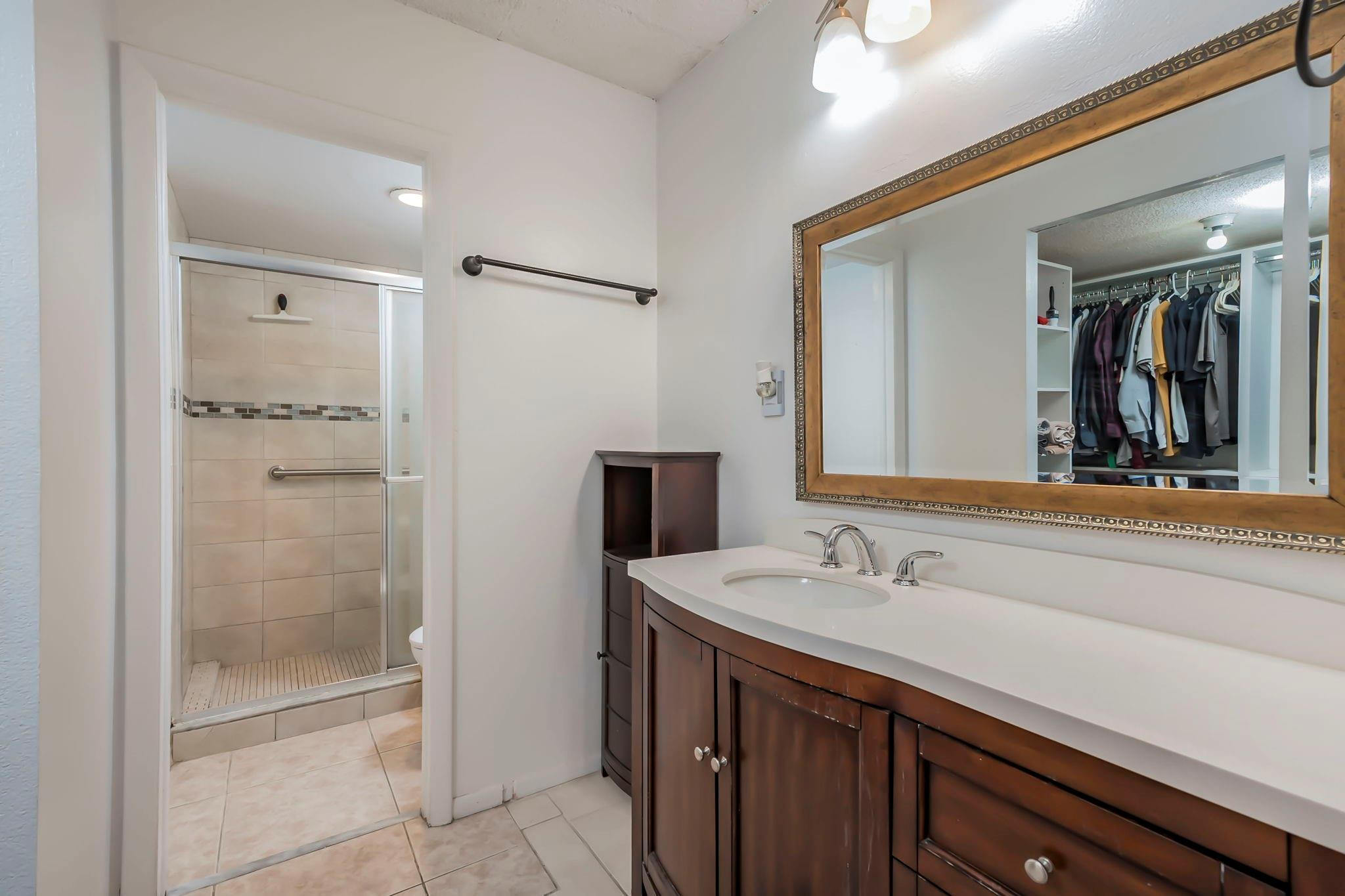 9401 Lime Bay Boulevard, Unit 209 Tamarac, FL 33321 - Photo 12 of 24 a bathroom with a sink a shower and a mirror