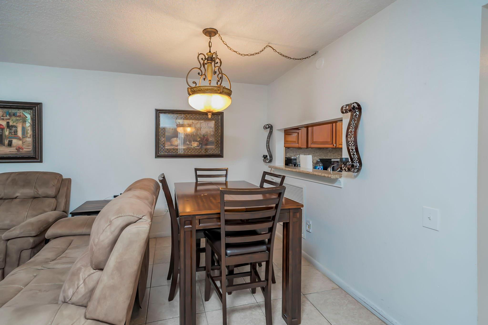 9401 Lime Bay Boulevard, Unit 209 Tamarac, FL 33321 - Photo 7 of 24 a view of a livingroom with furniture and a flat screen tv