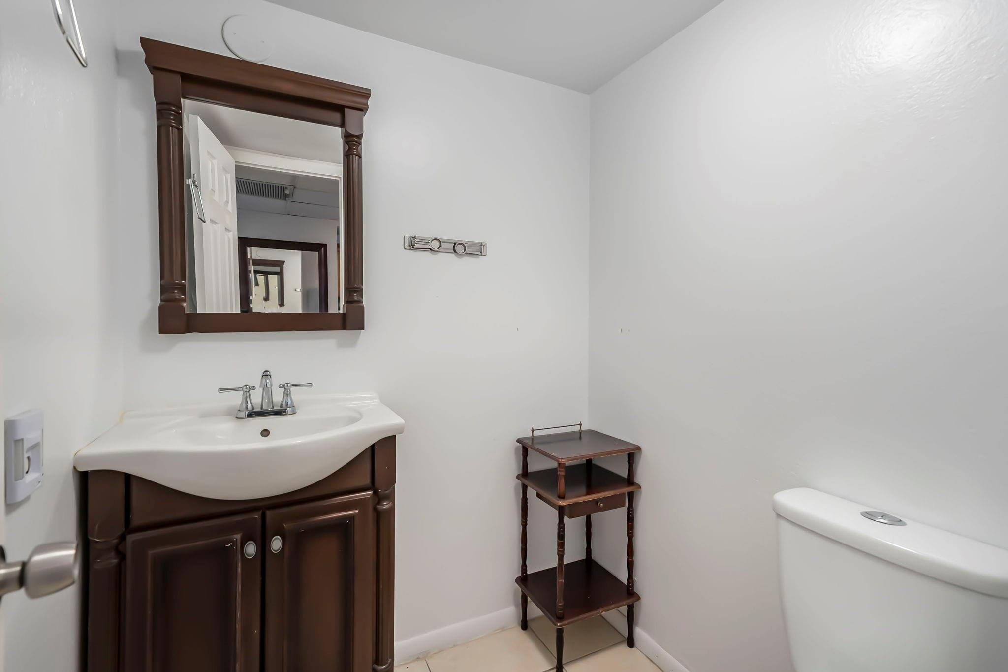 9401 Lime Bay Boulevard, Unit 209 Tamarac, FL 33321 - Photo 9 of 24 a bathroom with a sink and a toilet